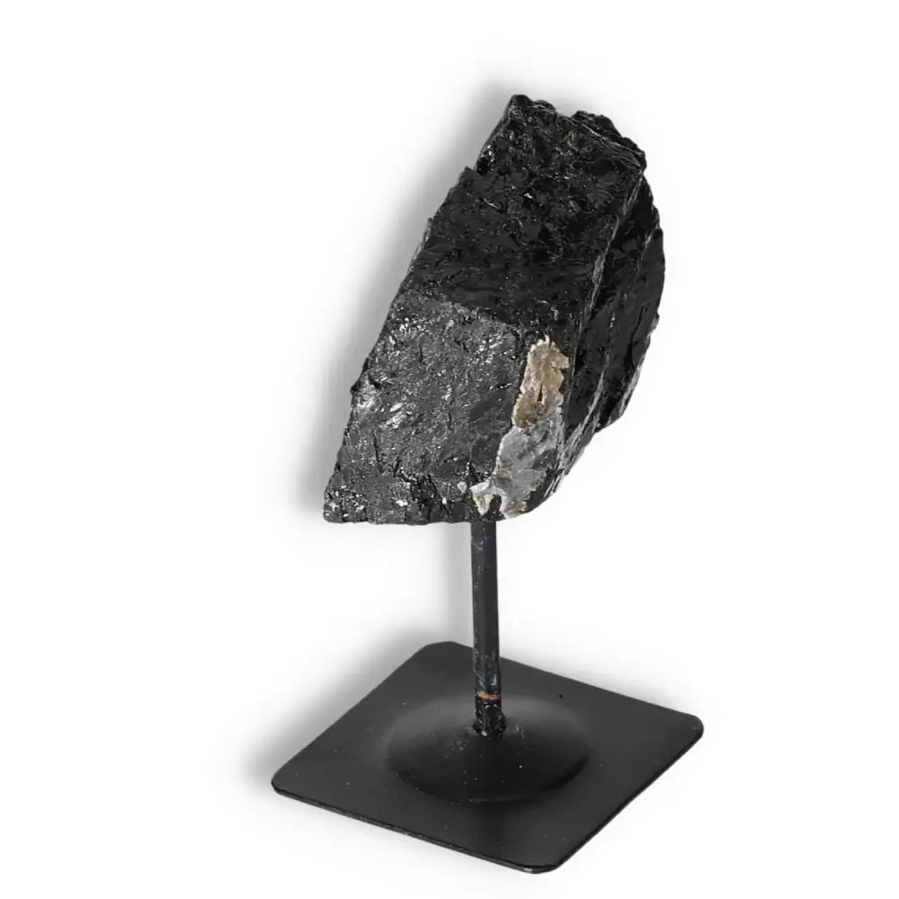 Rough Black Tourmaline on Metal Stand by Sylvia Crystals, showcasing natural luxury and spiritual depth, elevating decor aesthetics.