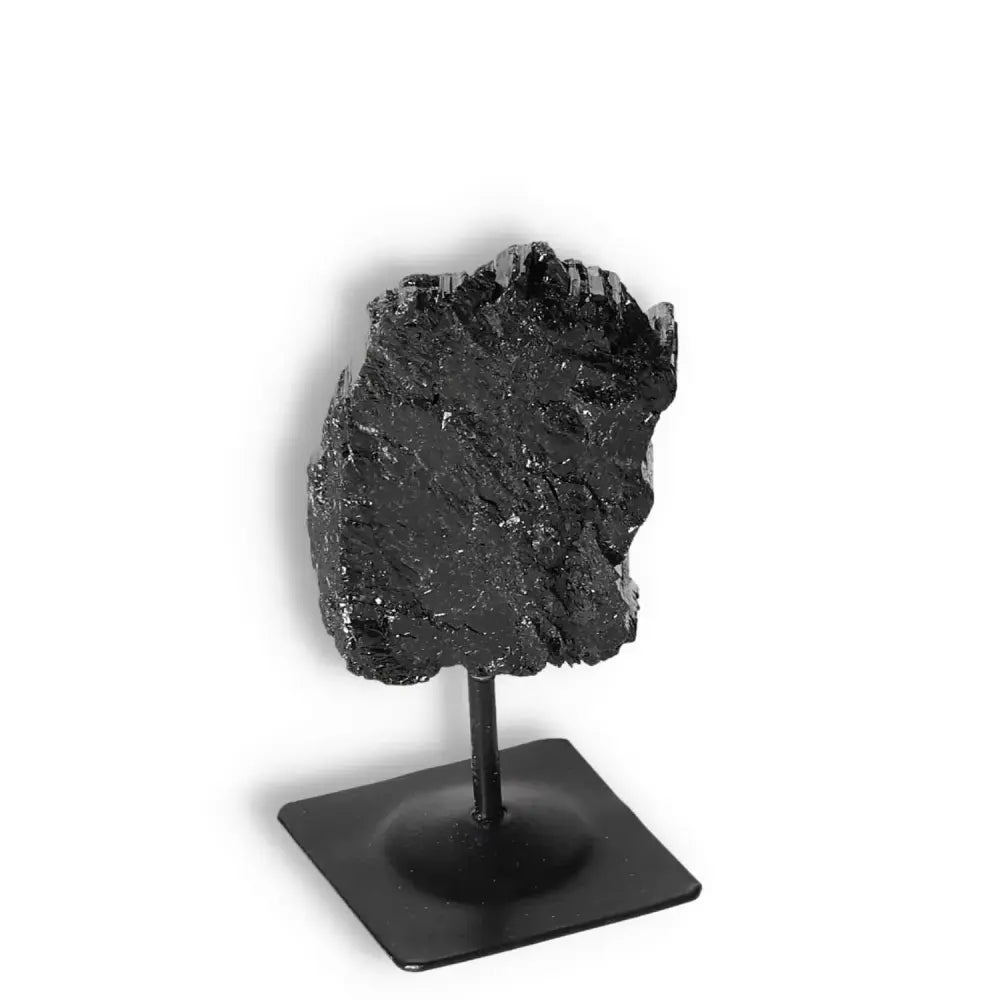 Elegant rough black tourmaline on metal stand, a premium decor item from Sylvia Crystals for energy transformation.