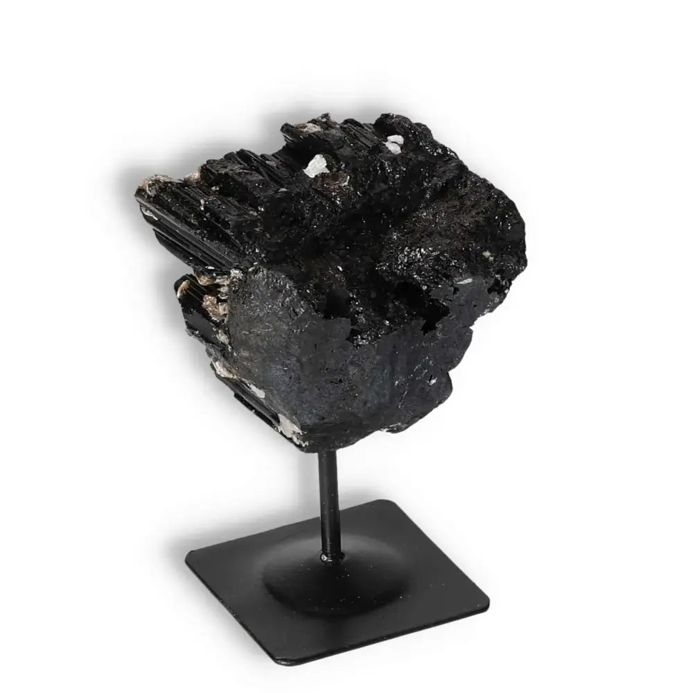 Rough Black Tourmaline on metal stand, ideal for cleansing energies and enhancing spiritual balance, from Sylvia Crystals collection.