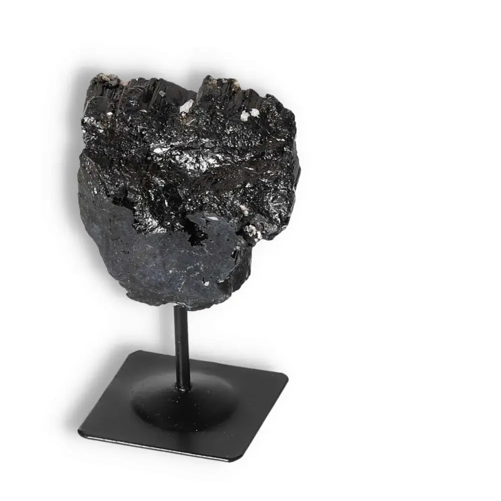 Rough Black Tourmaline on Metal Stand by Sylvia Crystals, perfect for spiritual cleansing and grounding. Ideal for enhancing harmony.