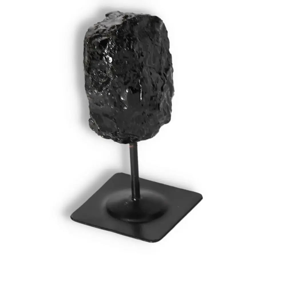 Rough Black Tourmaline on metal stand, luxurious gemstone for spiritual energy cleansing by Sylvia Crystals, premium quality.