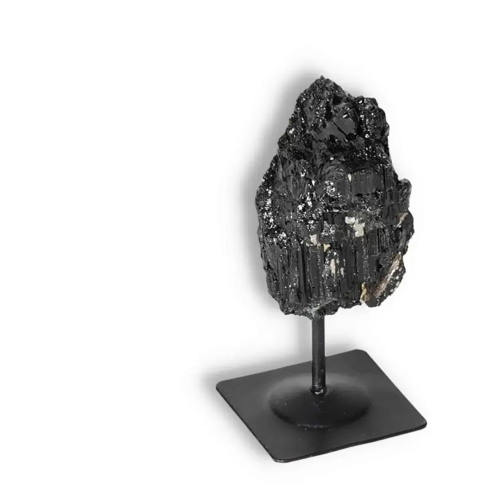 Rough Black Tourmaline with metal stand, premium crystal from Sylvia Crystals, known for cleansing negative energies.