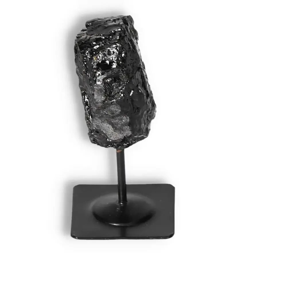 Rough Black Tourmaline on metal stand, luxury gemstone for energy-cleansing by Sylvia Crystals.