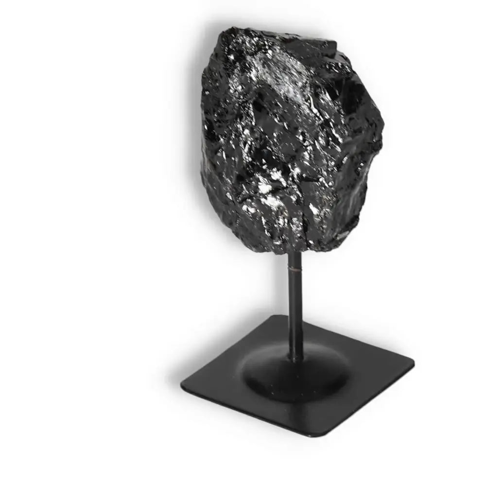 Rough Black Tourmaline on Metal Stand by Sylvia Crystals, showcasing luxury and energy-cleansing properties. Premium gemstone.