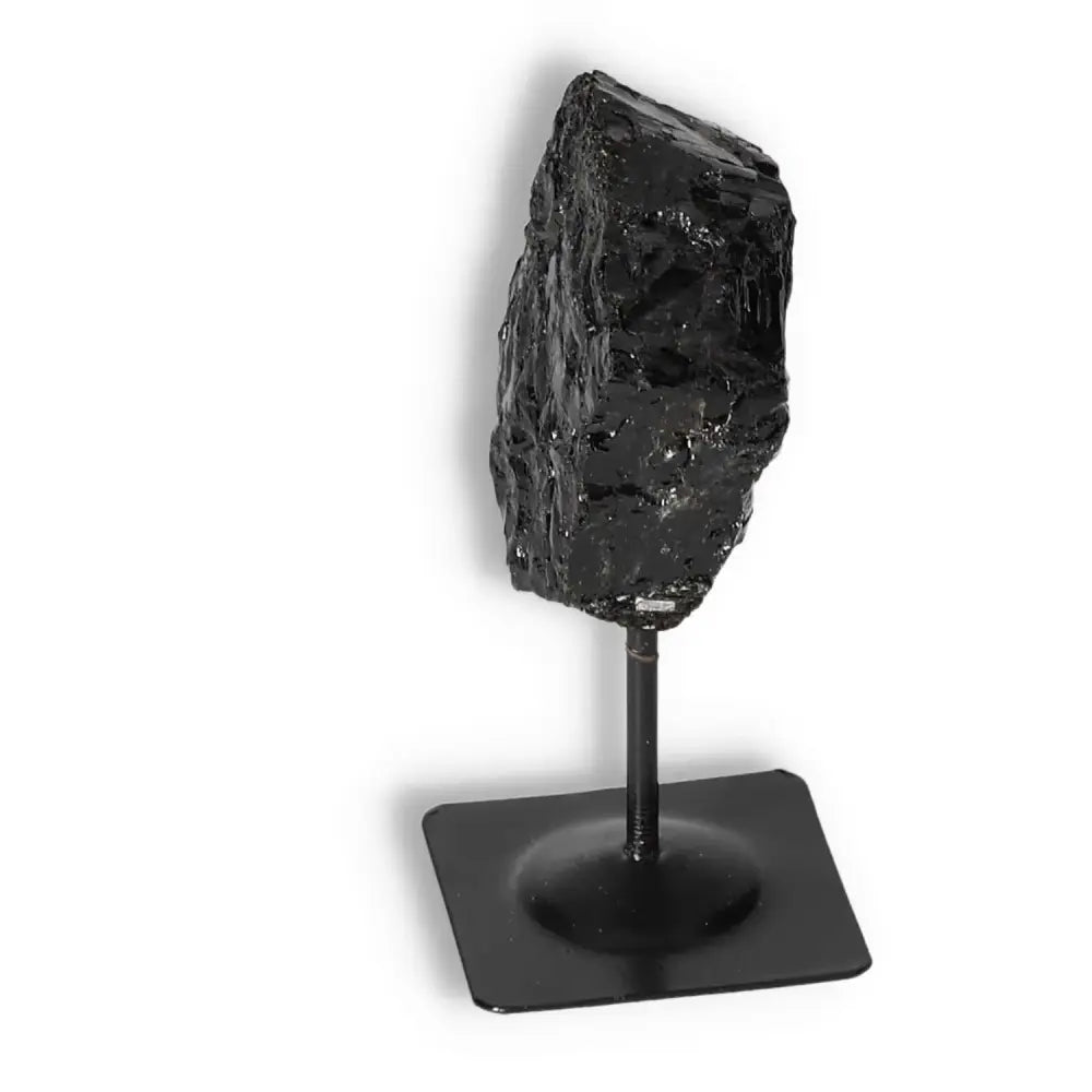 Rough Black Tourmaline on metal stand, premium gemstone for energy cleansing, from Sylvia Crystals.