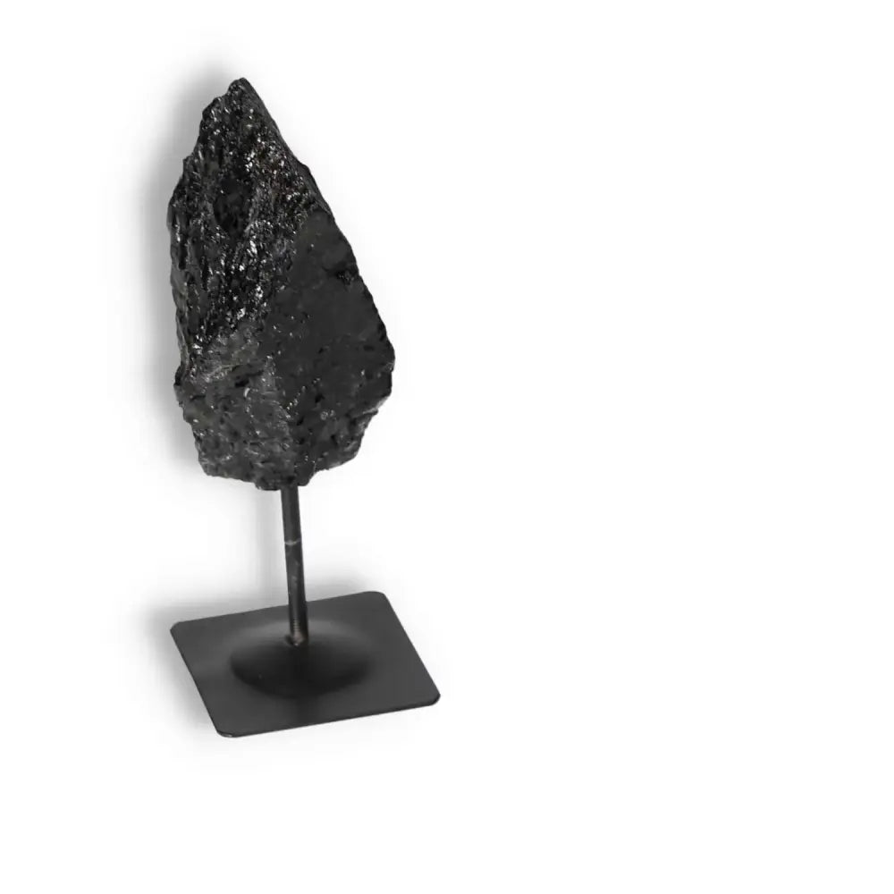 Rough Black Tourmaline with Metal Stand S from Sylvia Crystals, showcasing its natural beauty and cleansing properties.