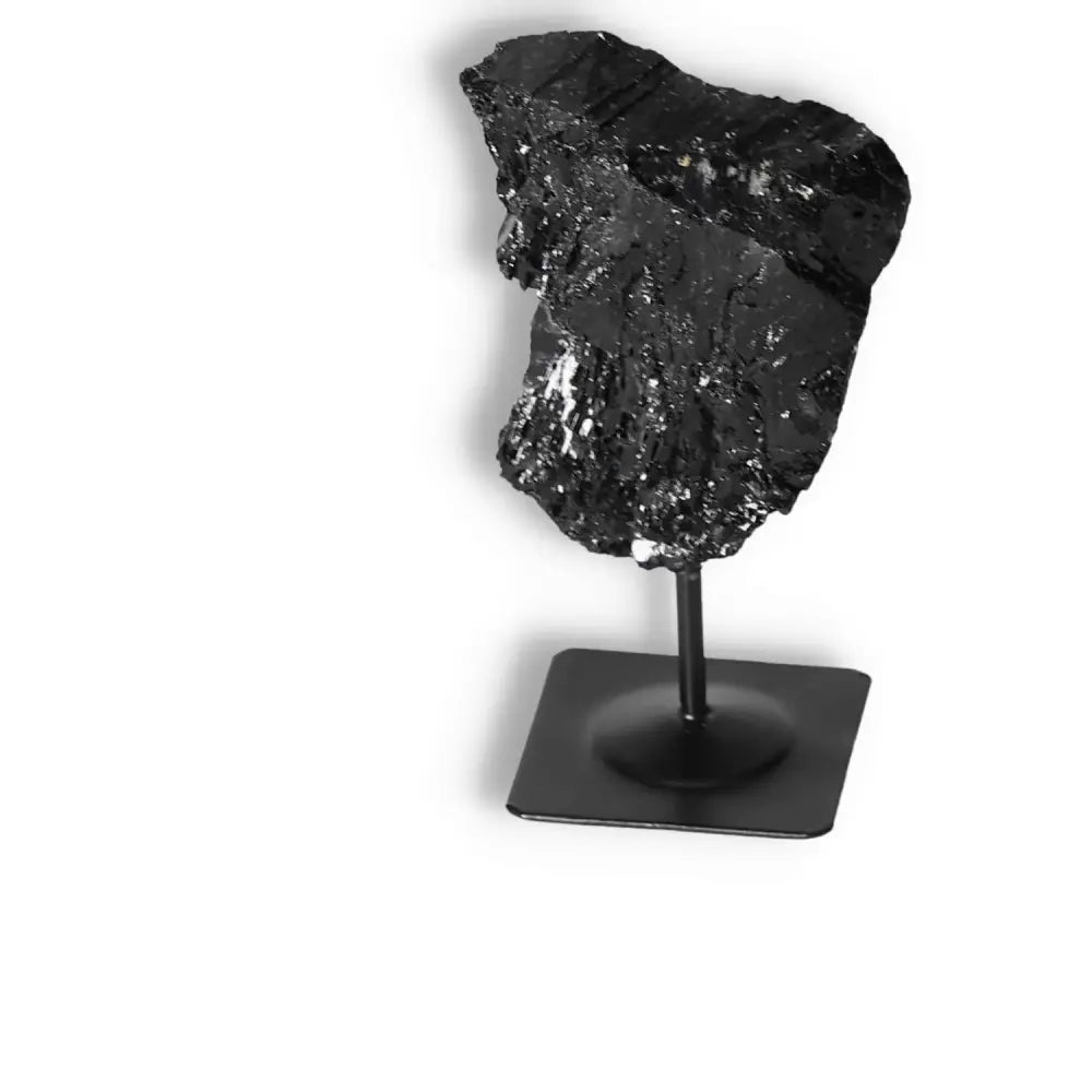 Rough Black Tourmaline on metal stand, ideal for energy cleansing and emotional grounding by Sylvia Crystals.