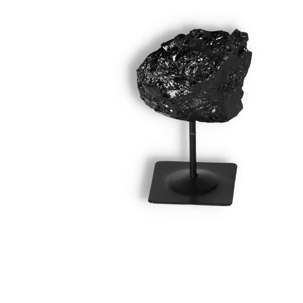 Rough Black Tourmaline on Metal Stand S symbolizes cleansing, transformative power, ideal for dissipating negative energies.