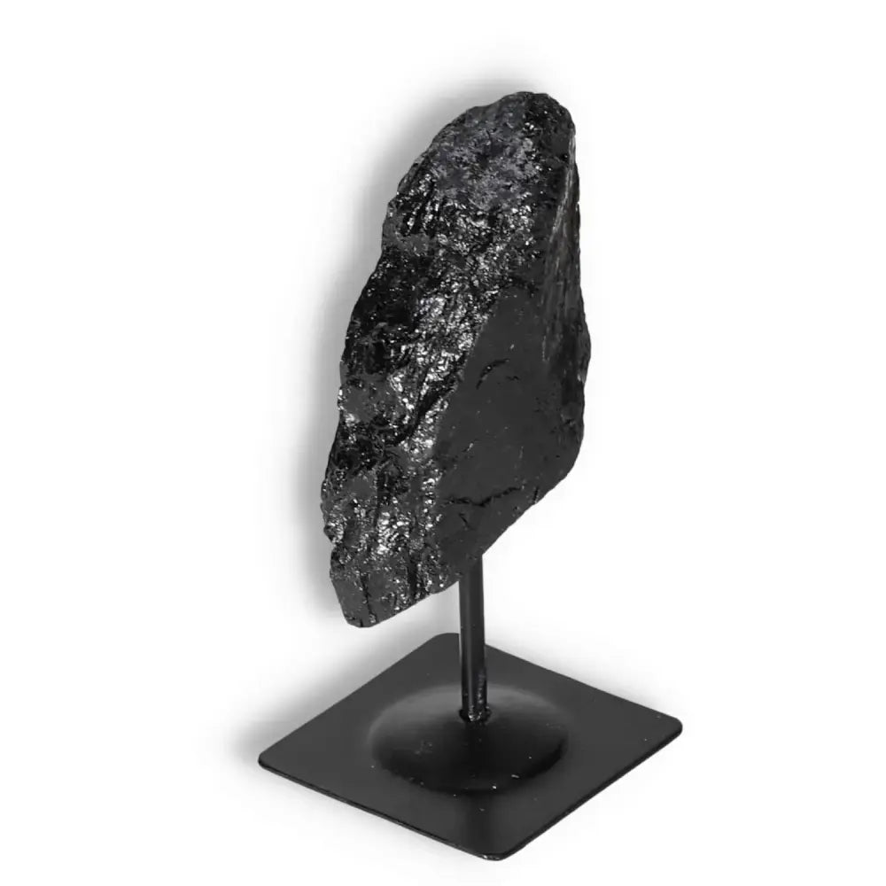 Rough Black Tourmaline on Metal Stand S from Sylvia Crystals, known for dispelling negative energies and promoting transformation.