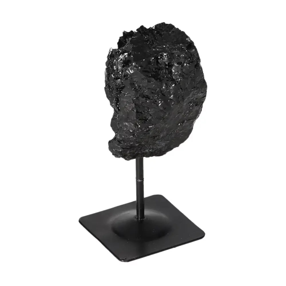 Rough Black Tourmaline with Metal Stand S, a potent tool for dissipating negative energies, from Sylvia Crystals.