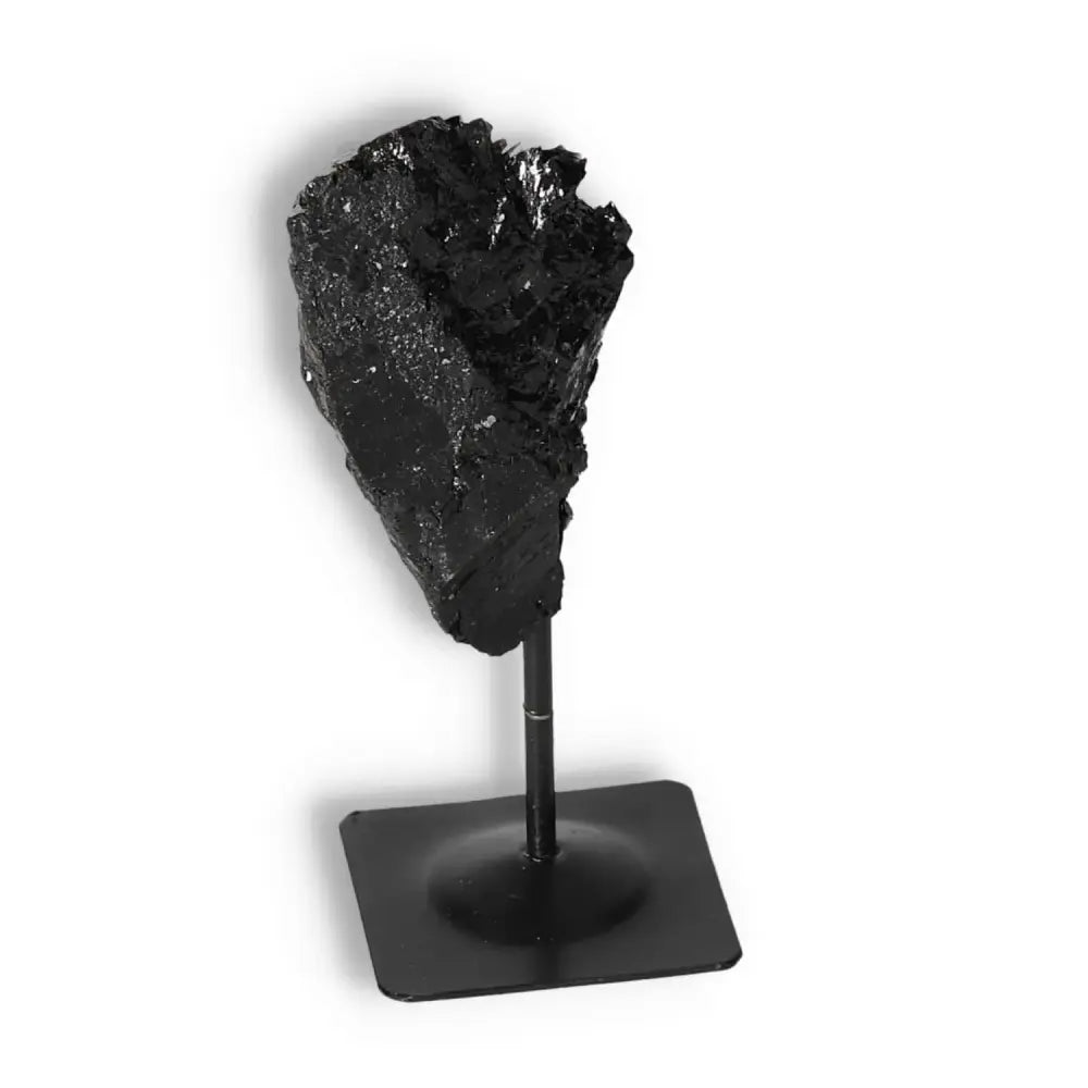 Rough Black Tourmaline on metal stand from Sylvia Crystals, ideal for dispelling negative energy and enhancing home decor.