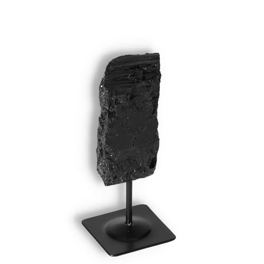 Rough Black Tourmaline on Metal Stand from Sylvia Crystals, known for energy cleansing and transformation.