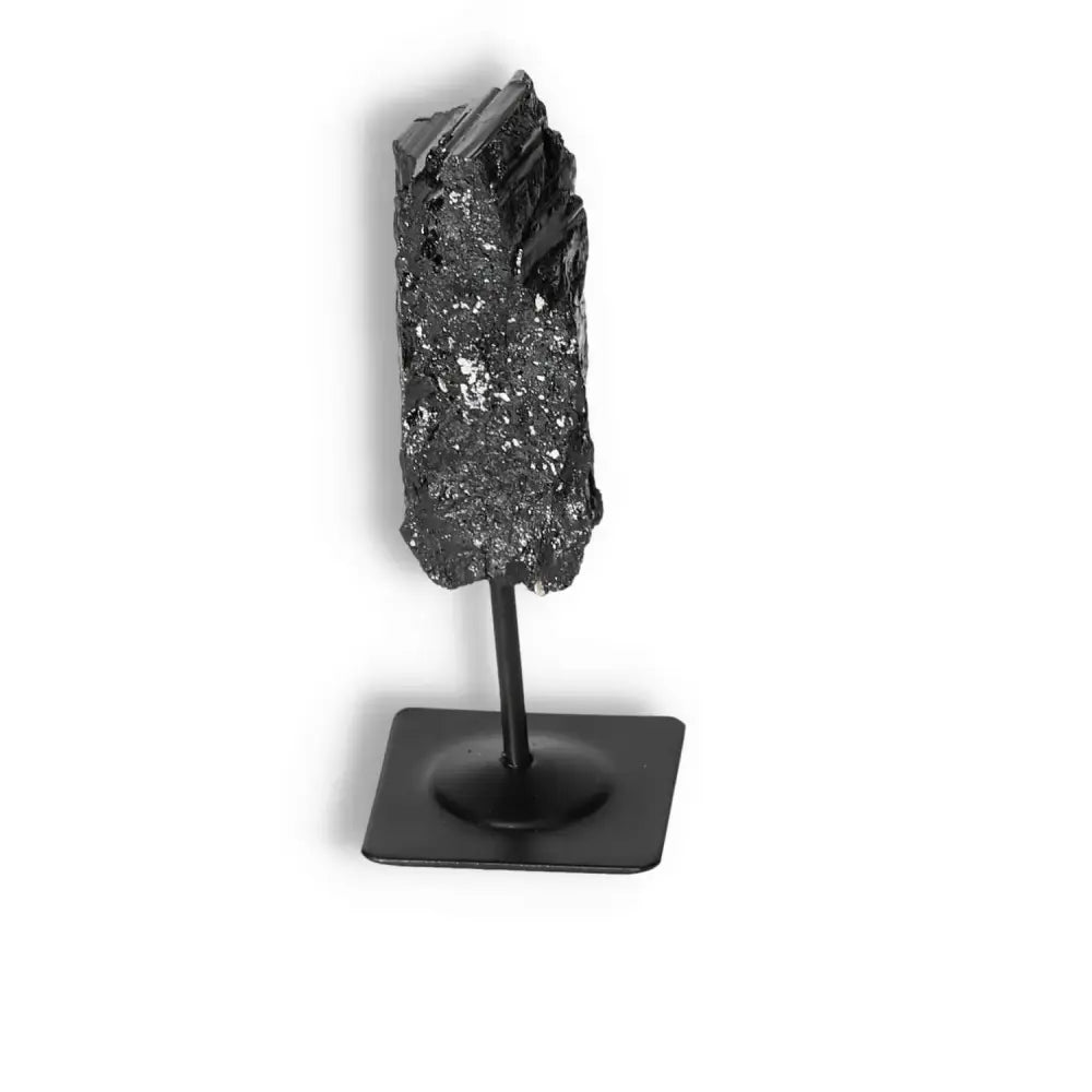 Rough Black Tourmaline with Metal Stand S, premium crystal from Sylvia Crystals, cleanses negative energy, shown on sleek display.