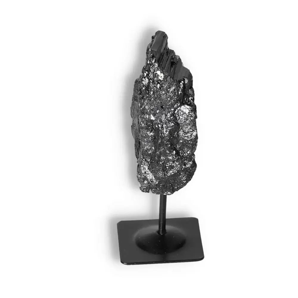 Rough Black Tourmaline with Metal Stand S by Sylvia Crystals, renowned for cleansing negative energies, on a sleek stand.