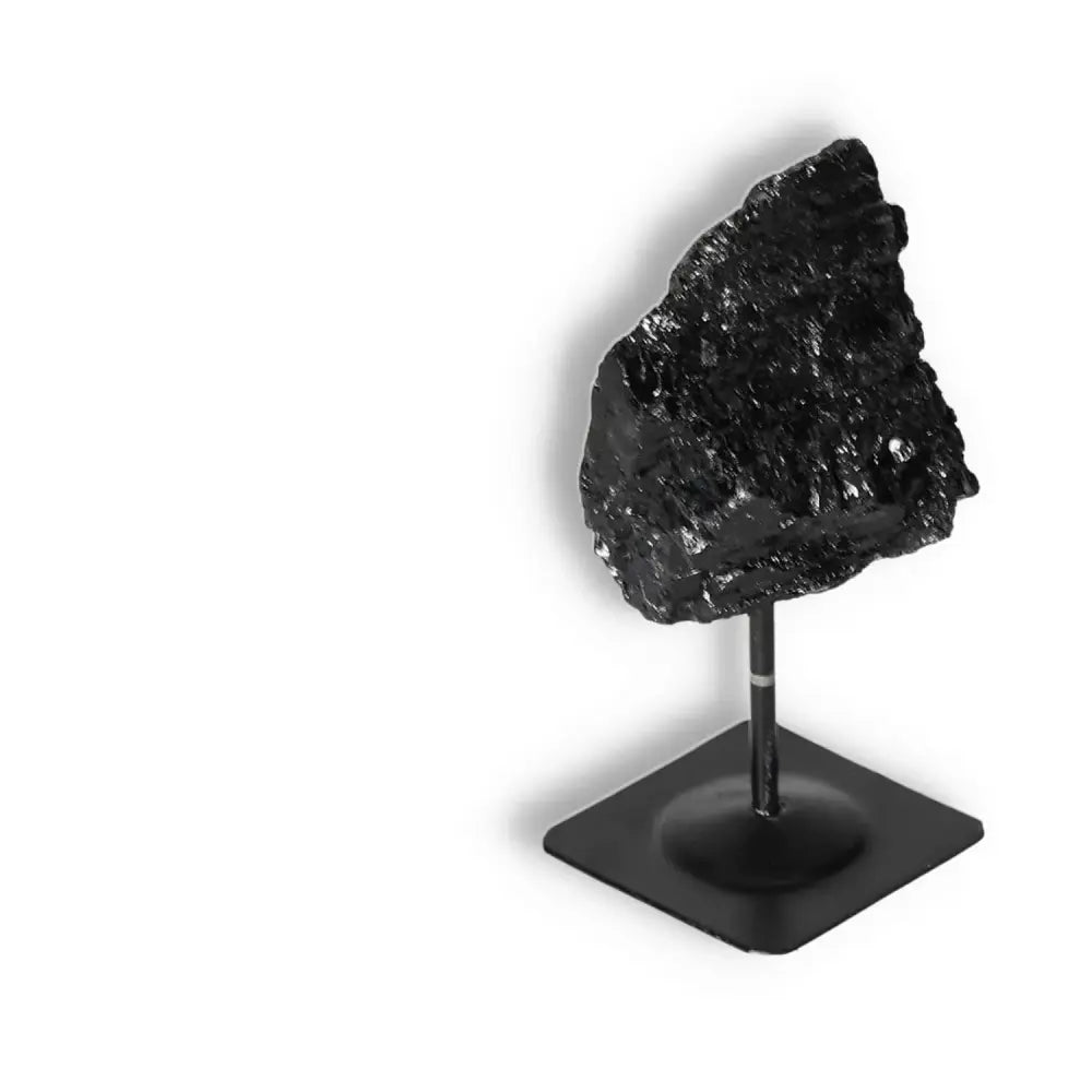 Rough Black Tourmaline on metal stand, ideal for energy cleansing and spiritual enhancement, by Sylvia Crystals.
