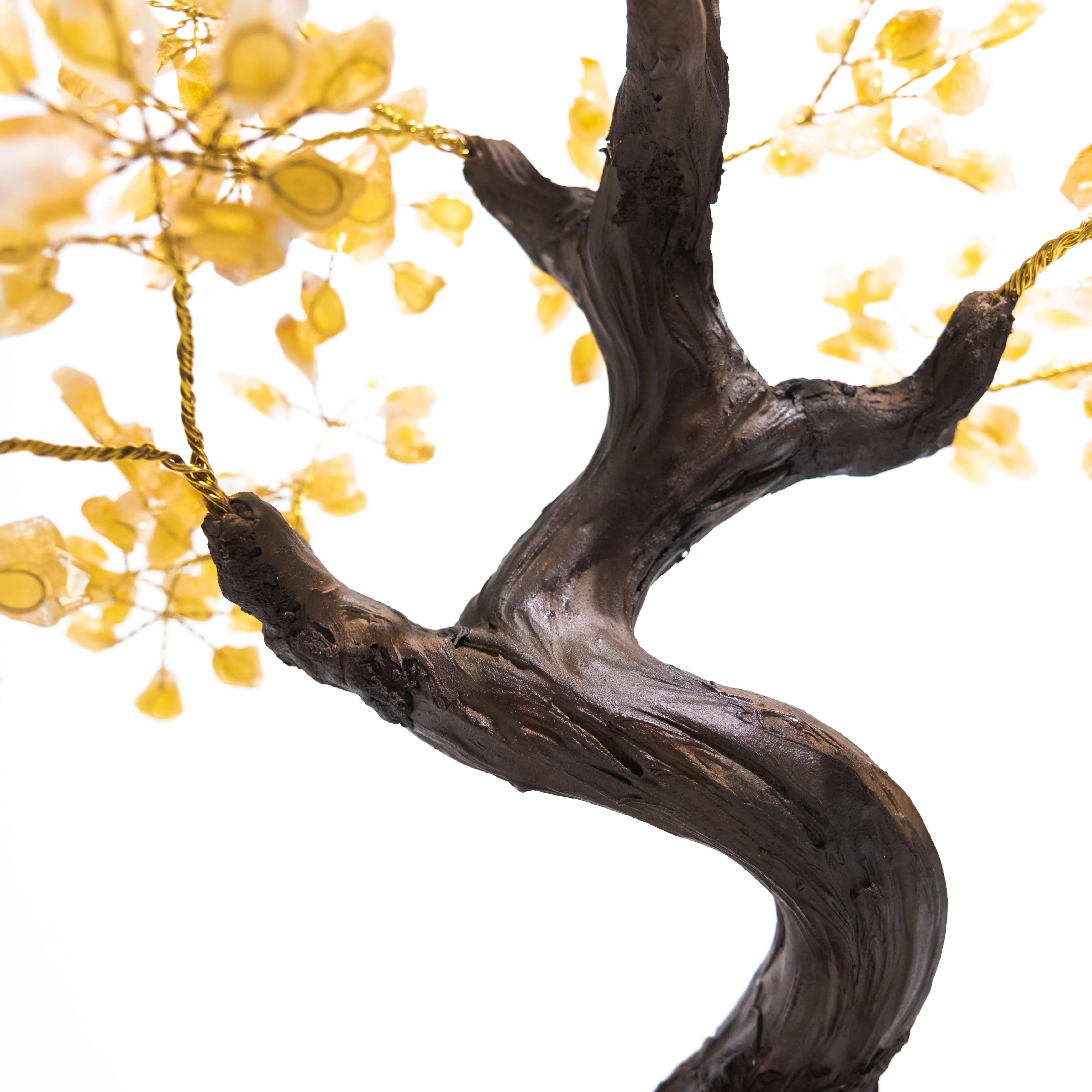 Close-up of handcrafted citrine crystal bonsai tree with intricate details, symbolizing prosperity and positive energy.