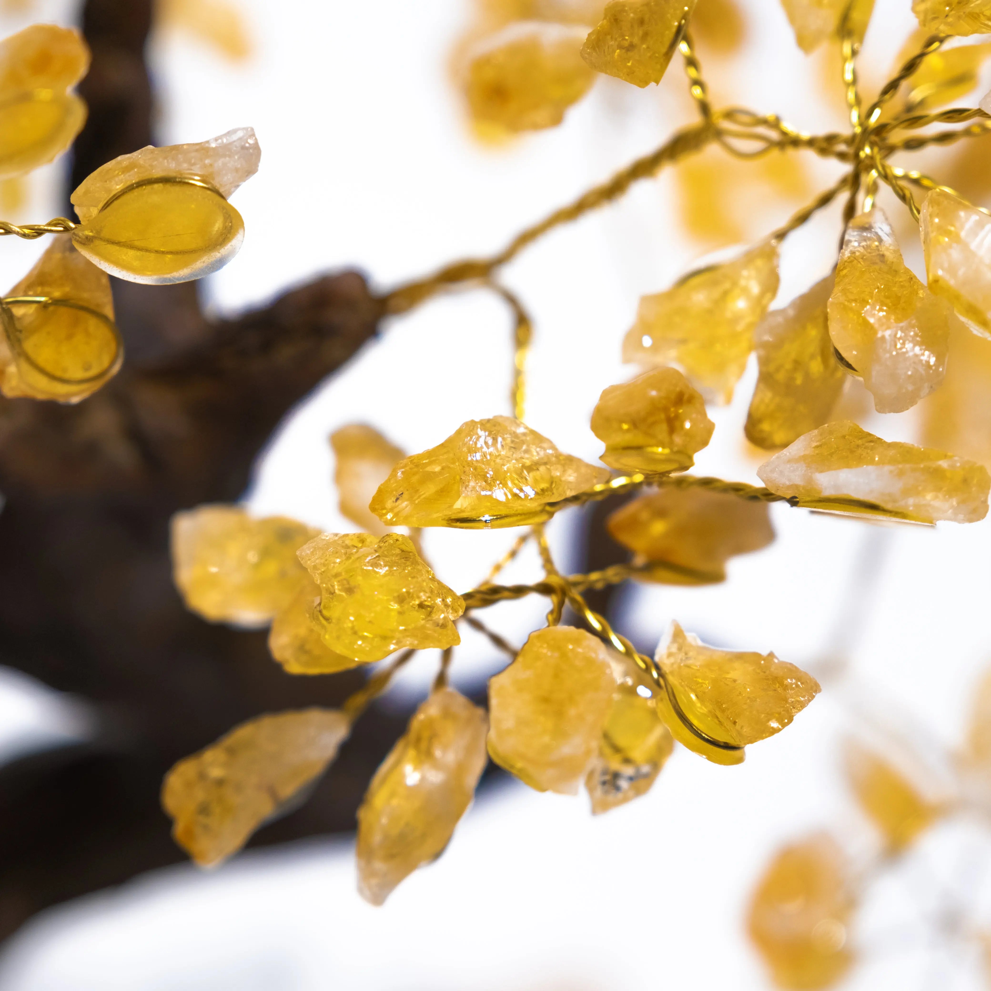 Close-up of handcrafted Citrine Crystal Bonsai Tree branches with warm yellow gemstones, symbolizing prosperity and positive energy.