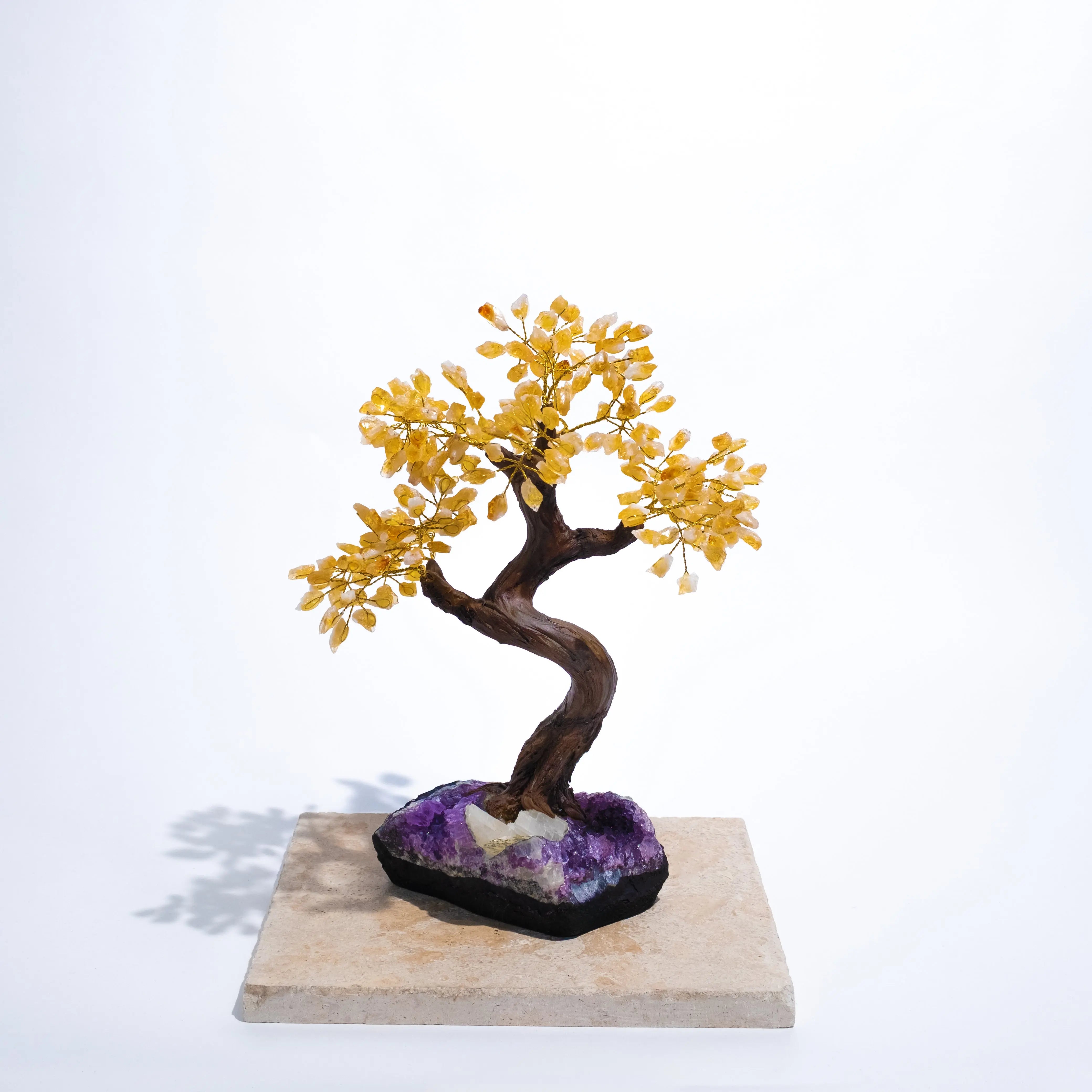 Handcrafted Citrine Crystal Bonsai Tree on purple base, promoting prosperity, abundance, and positive energy in any space.