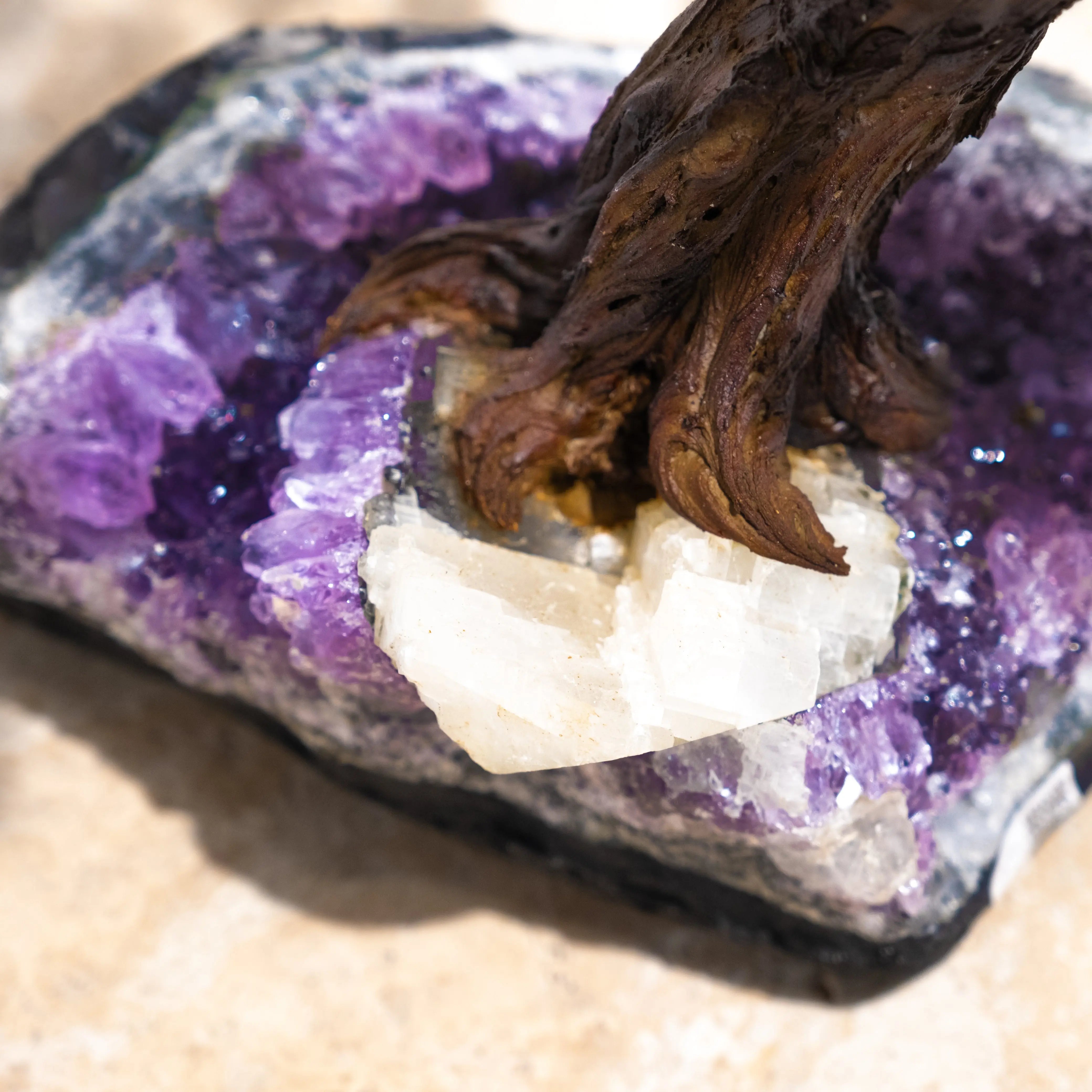 Close-up of a Citrine Crystal Bonsai Tree base with purple and white gemstones, symbolizing prosperity and positive energy.