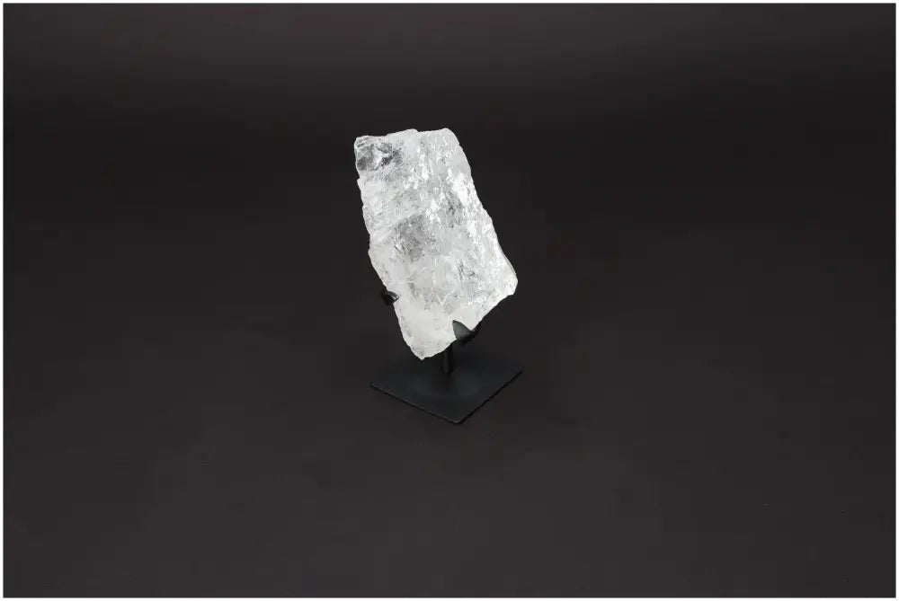 Rough Clear Quartz on metal stand, premium quality by Sylvia Crystals, known for energy harmonizing and amplification properties.