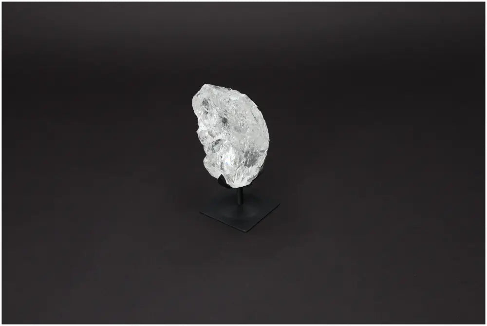 Rough Lemurian Quartz on metal stand, luxury crystal decor by Sylvia Crystals known for purification properties.