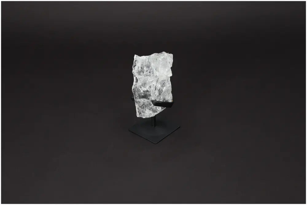 Rough Clear Quartz on metal stand showcasing its natural beauty and energy-boosting properties for mind and body harmony.
