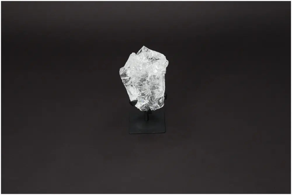 Rough Lemurian Quartz on elegant metal stand showcasing natural clarity and purity, premium product from Sylvia Crystals.