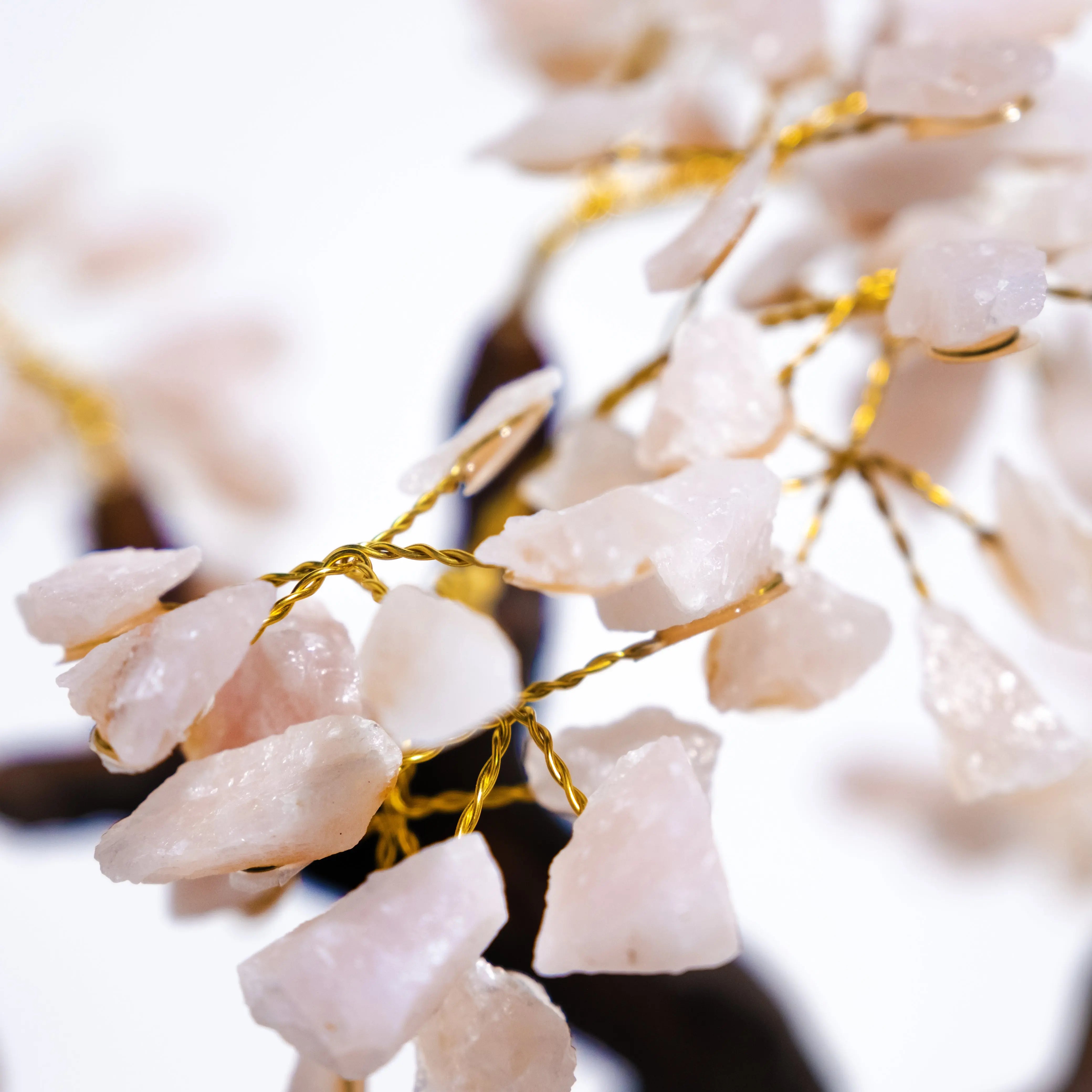 Close-up of a Rough Rose Quartz Bonsai Tree showing pink quartz crystals and golden wires, enhancing positive energy and elegant décor.