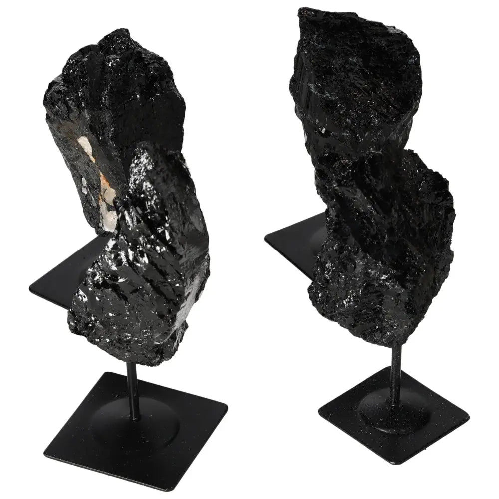 Rough Tourmaline on sleek metal stand, showcasing deep black hues and natural textures. Perfect for decor and crystal collections.