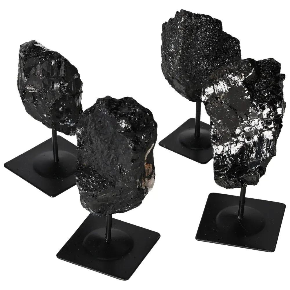 Rough tourmaline crystals on metal stands showcasing natural beauty and elegance, ideal for home decor and crystal enthusiasts.
