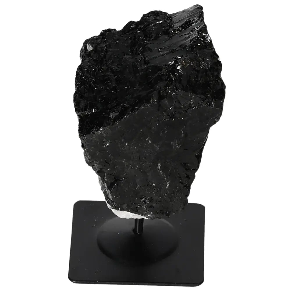 Rough black tourmaline crystal on metal stand from Sylvia Crystals, showcasing natural beauty and vibrant prismatic structures.