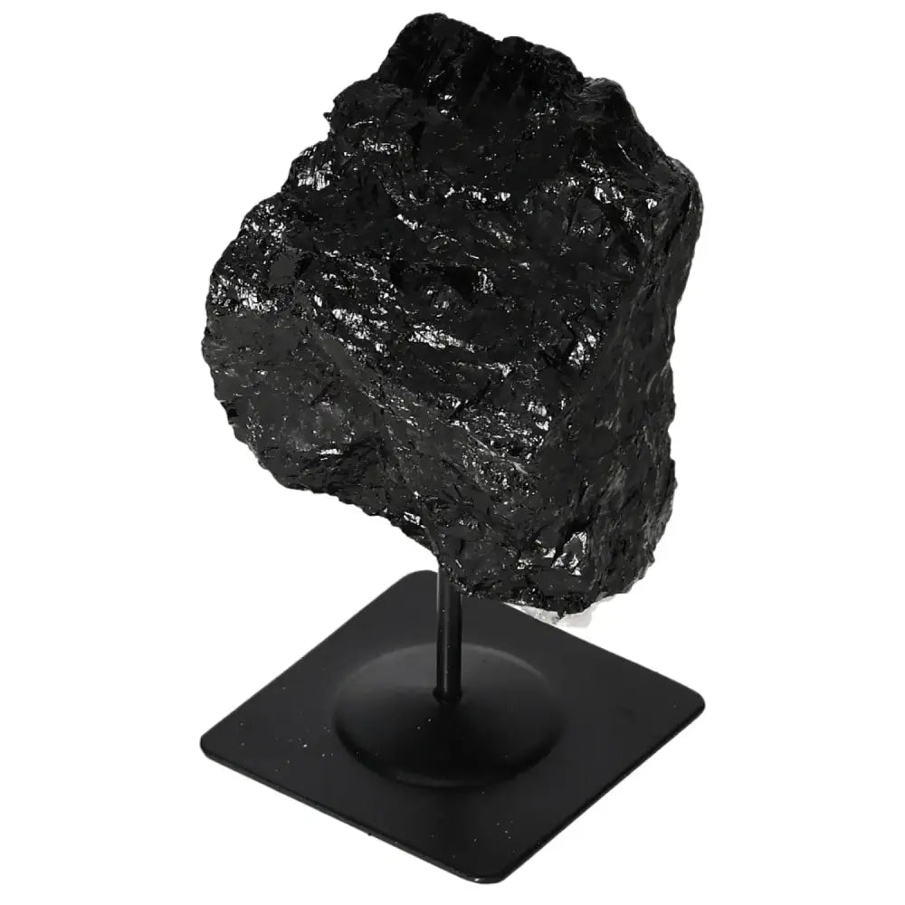 Rough black tourmaline on metal stand, showcasing natural prismatic crystals; a unique decorative piece by Sylvia Crystals.