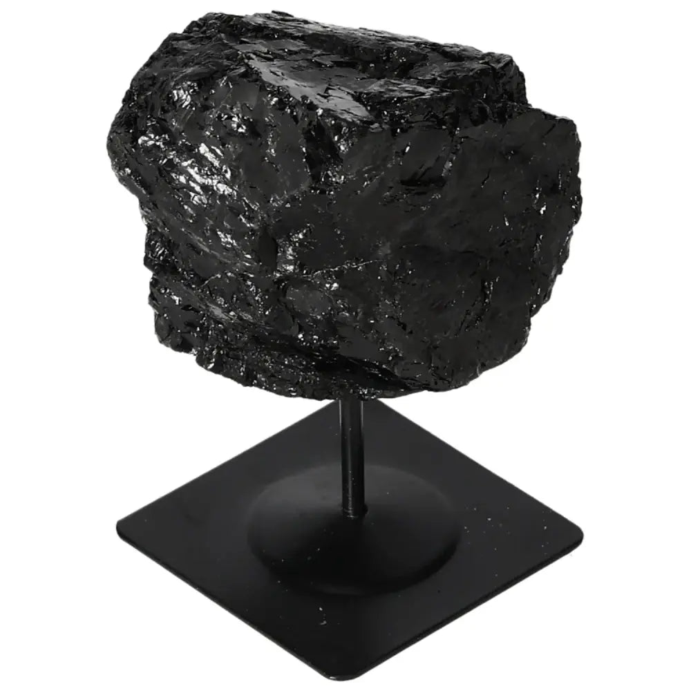 Rough black tourmaline crystal on a metal stand by Sylvia Crystals, showcasing natural beauty and vibrant color spectrum in home decor.