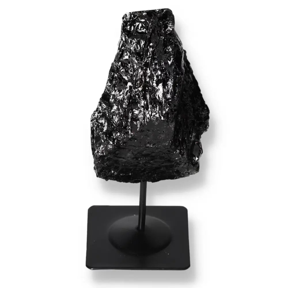 Rough black tourmaline on metal stand from Sylvia Crystals, showcasing natural elegance and stability, perfect for home decor.