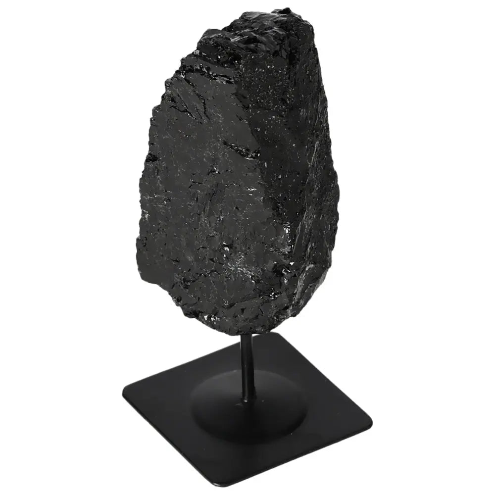 Rough black tourmaline on metal stand from Sylvia Crystals, showcasing raw beauty and energy-balancing properties. Premium quality.