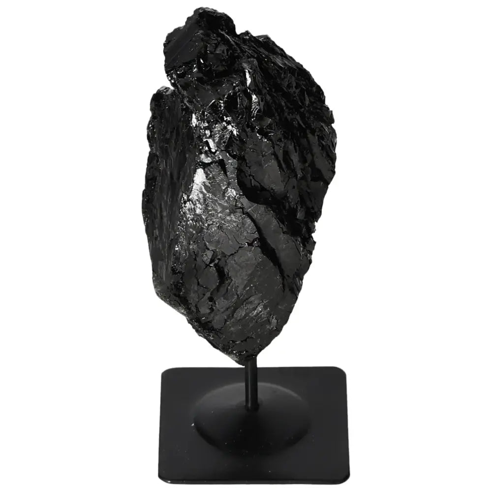 Rough tourmaline gemstone displayed on elegant metal stand, adding modern sophistication and natural beauty to any decor.