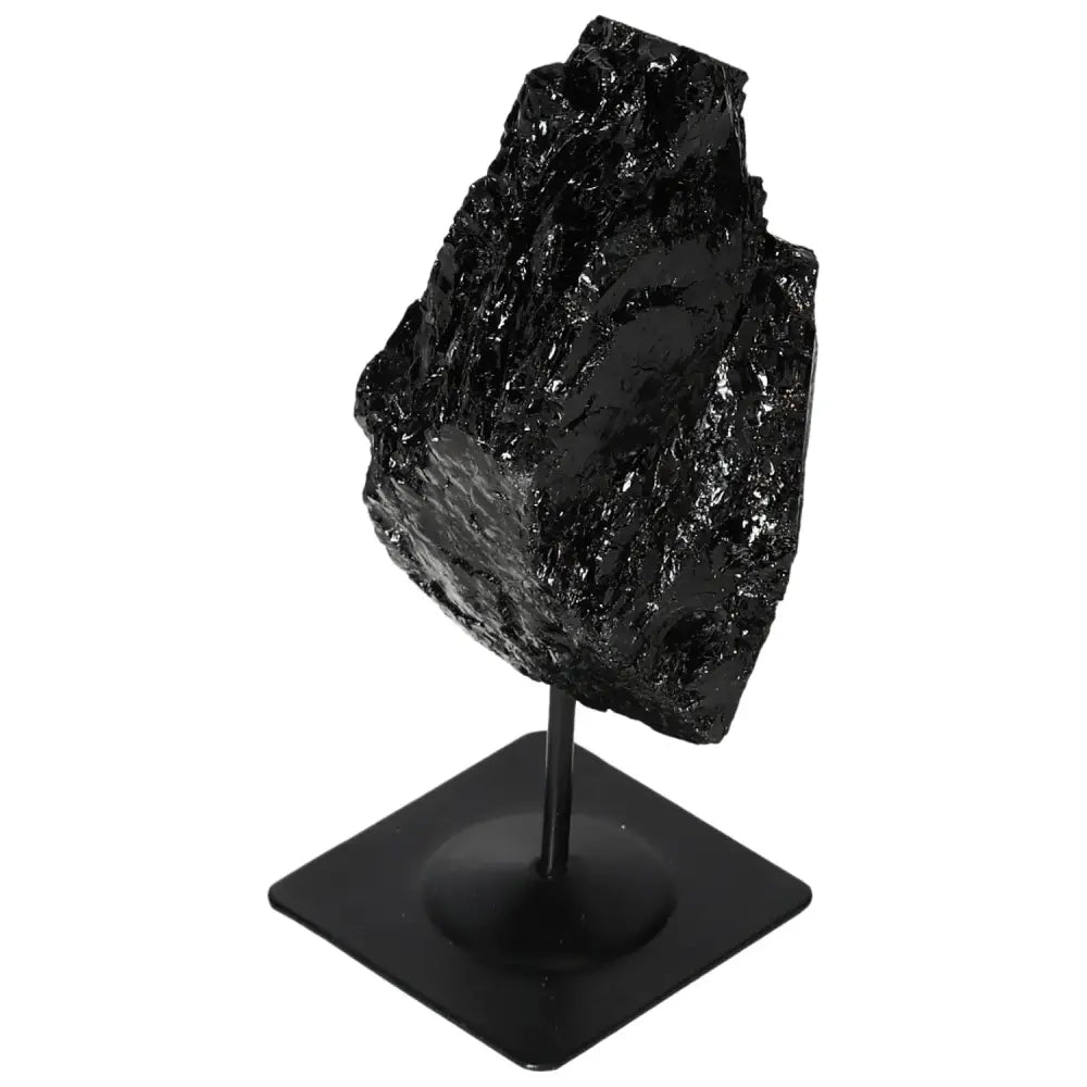 Rough tourmaline crystal on a metal stand, showcasing its deep black color and natural texture, perfect for elegant home decor.