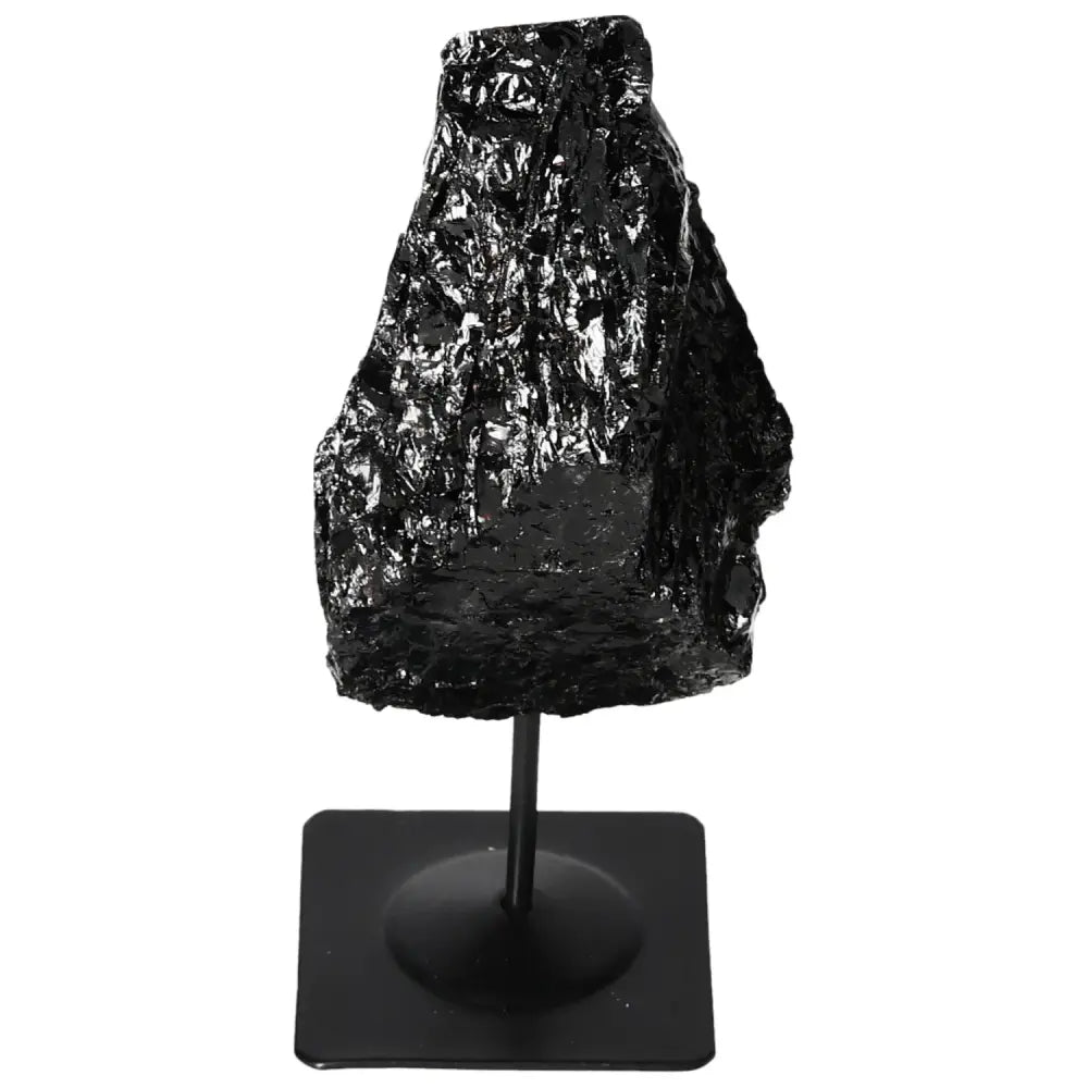 Rough black tourmaline crystal on a metal stand, premium Sylvia Crystals home decor piece.