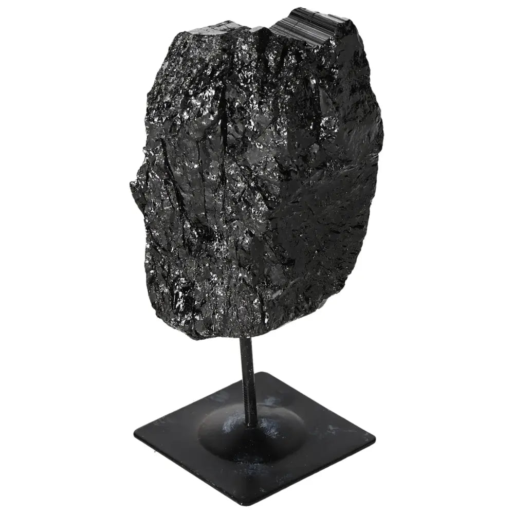 Rough black tourmaline crystal on metal stand, showcasing natural beauty and elegance from Sylvia Crystals.