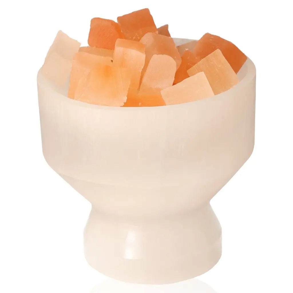 Selenite bowl filled with Himalayan salt chunks for ambient lighting and natural decor, promoting positive energy and calm.