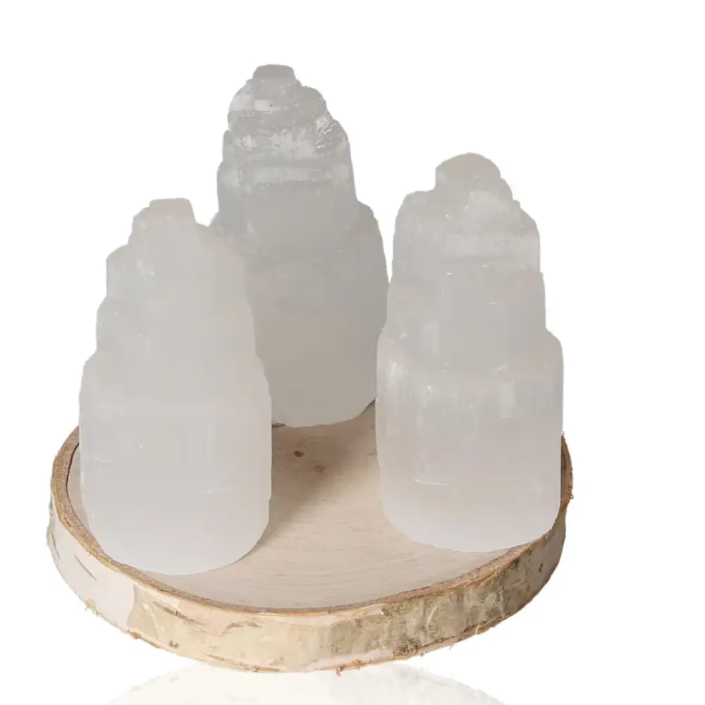 Elegant 6cm selenite towers with glass-like transparency, ideal for creating a serene and balanced atmosphere, displayed on a wooden base.