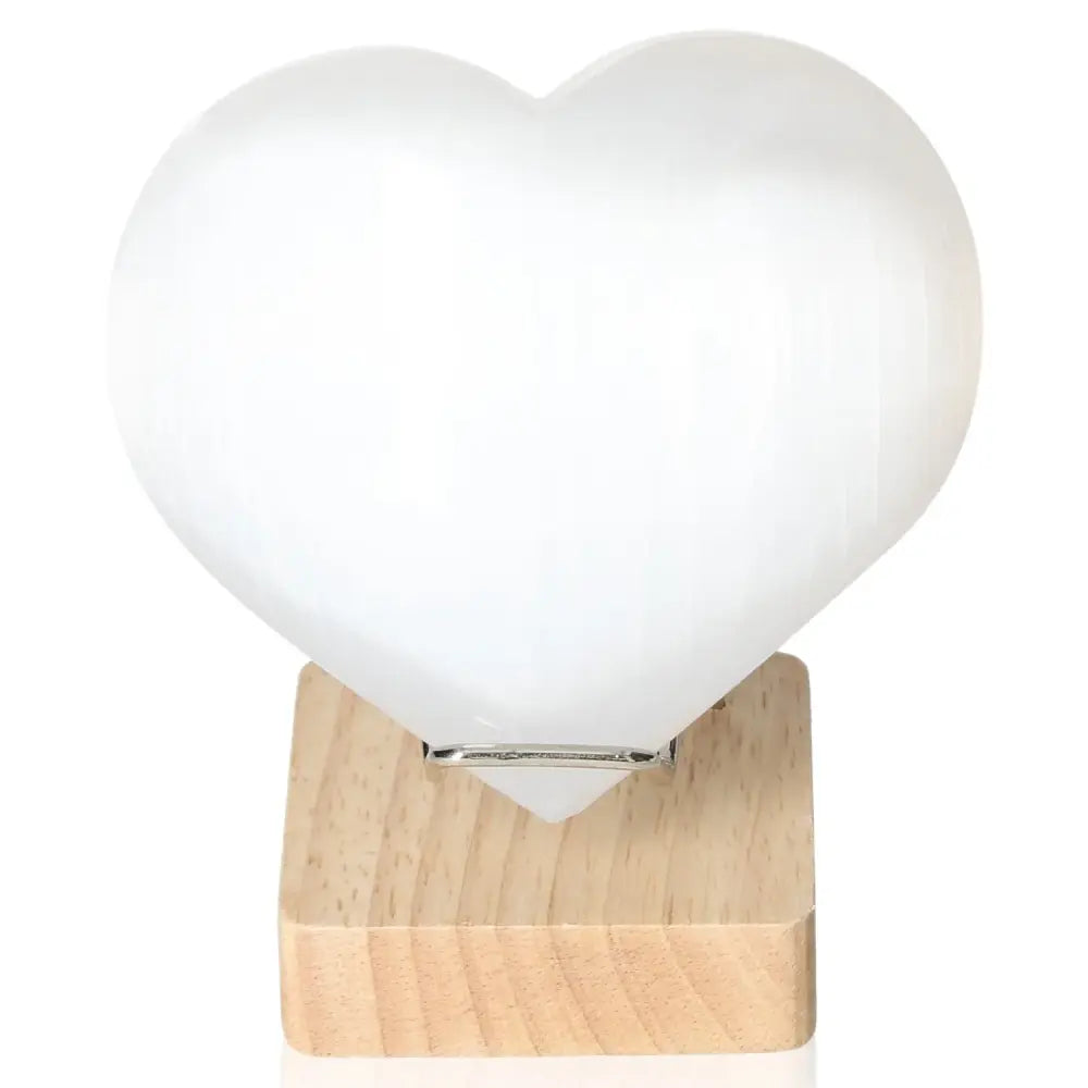 Heart-shaped 12cm Selenite crystal on wooden base by Sylvia Crystals, ideal for spiritual growth and mindful living.