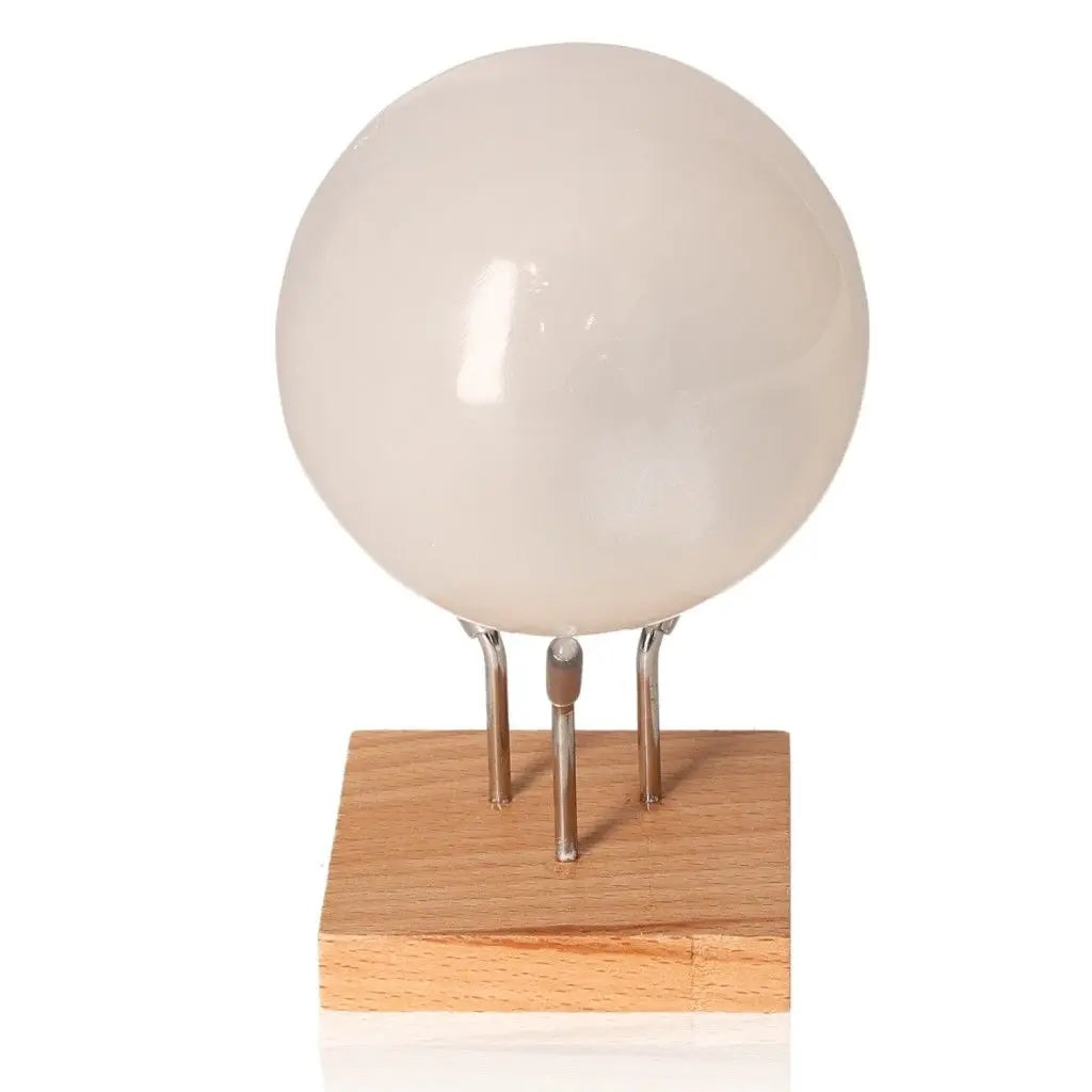 Selenite sphere 8cm displayed on wooden stand for spiritual growth from Sylvia Crystals