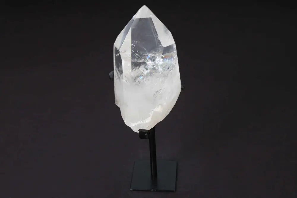 Semi polished clear quartz point on a stand, perfect for energy amplification and meditation. Known as a Master Healer crystal.