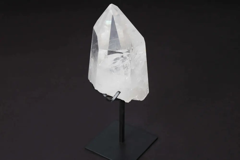 Semi Polished Clear Quartz Point on Stand, ideal for amplifying energy and clarity in meditation and energy work.