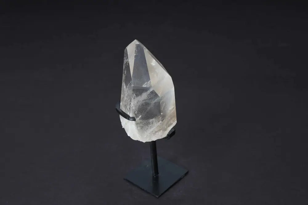 Semi-polished smoky quartz point with stand, showcasing natural edges and polished faces for elegant home decor and grounding energy.
