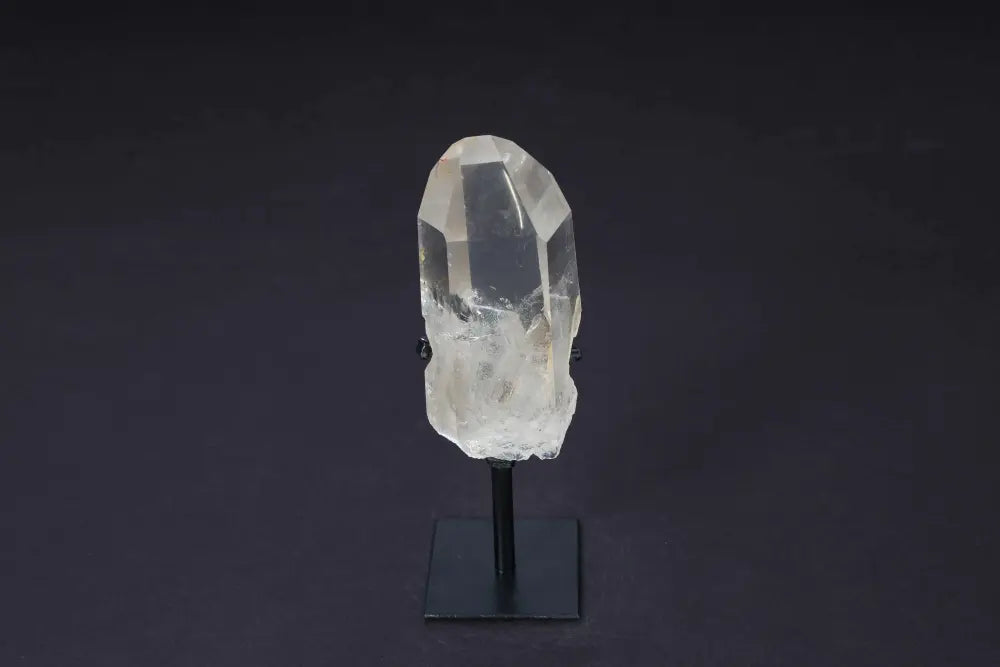 Semi-polished smoky quartz point on stand, showcasing rich earthy tones and raw edges for decoration and protective energy.