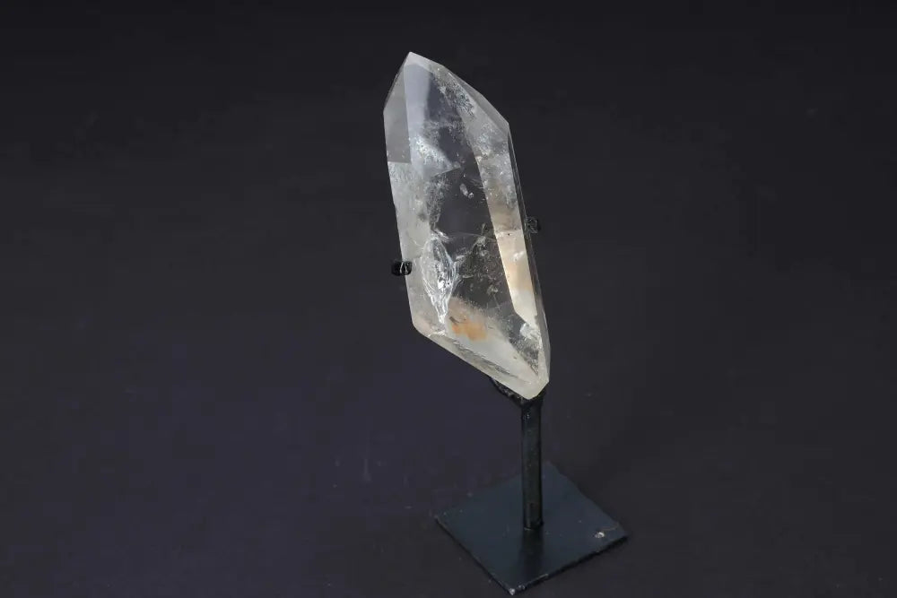 Semi-polished smoky quartz point with stand, showcasing earthy tones and sleek design for grounding and protection.