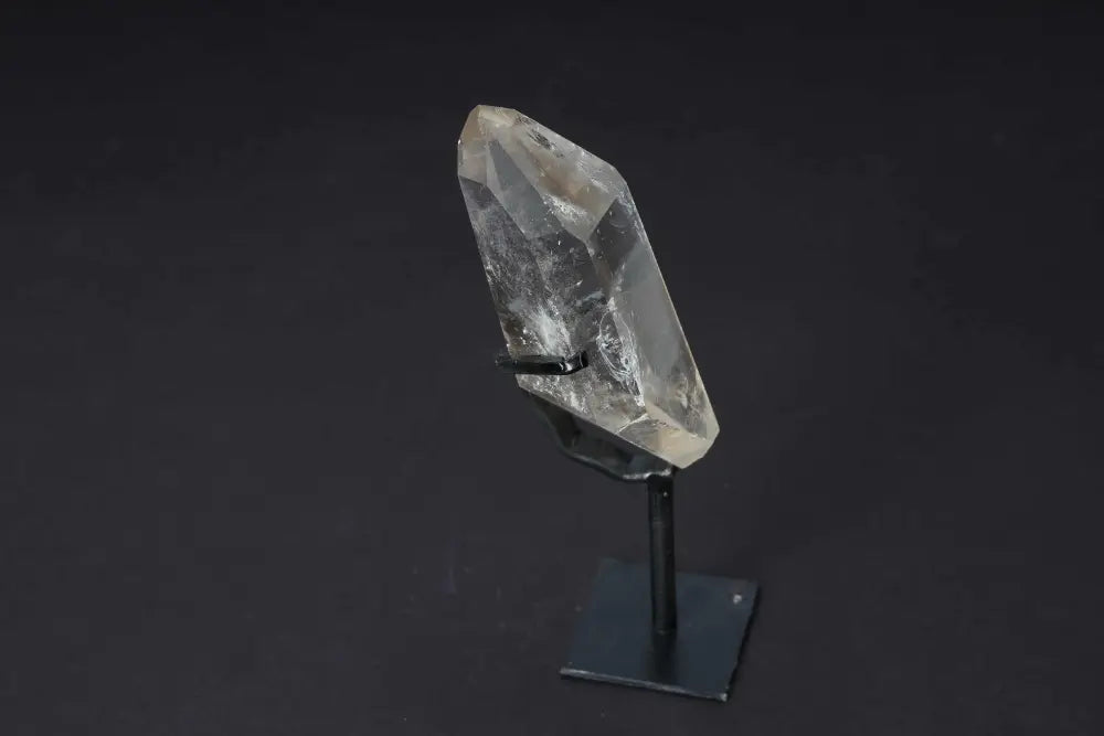Semi-polished smoky quartz point on stand, showcasing earthy tones and natural beauty, ideal for grounding and protection in decor.