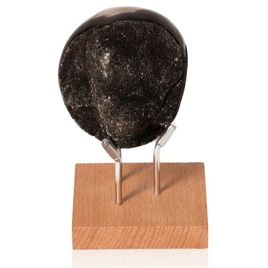 Septarian stone on a wooden stand, showcasing its unique mineral texture and rich symbolism in healing and power.